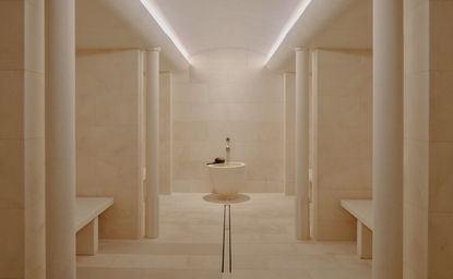 Spa steam room at Aman Le Mélézin resort with minimalist wood panelling and soft lighting.