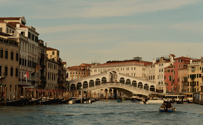Venetian palaces and the Rialto Bridge viewed across the Grand Canal at Aman Venice.