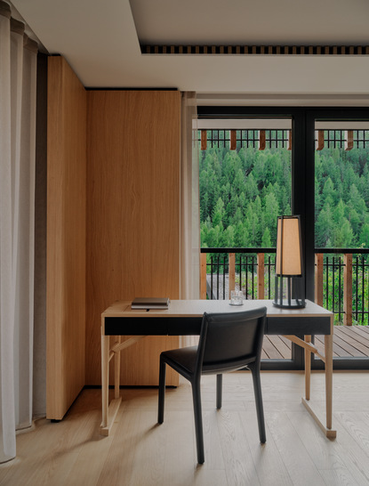 Deluxe Suite desk and chair with Alpine views at Aman Rosa Alpina, Italy.