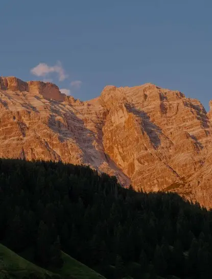 Dolomites mountains at golden hour, Aman Rosa Alpina resort.
