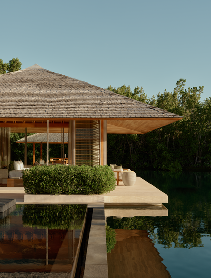 Villa pavilion with thatched roof overlooking water at Amanyara resort, Turks and Caicos.