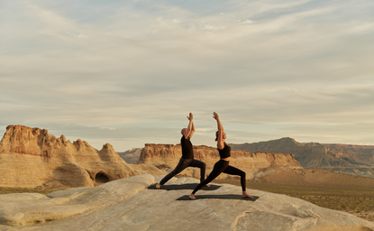 Yoga session on desert rocks at Amangiri resort, Utah.