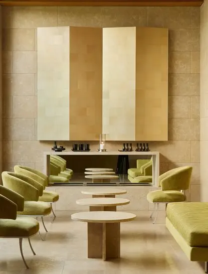 Serene wellness waiting room at Amanzoe with neutral tones, wooden furnishings and soft lighting.