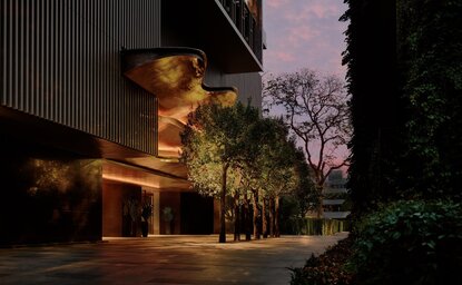 曼谷奈乐安缦酒店外观，夜间照明映照建筑与周围绿化。