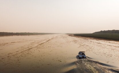 Small boat on the Chambal River at Aman-i-Khas, India, during a river cruise.
