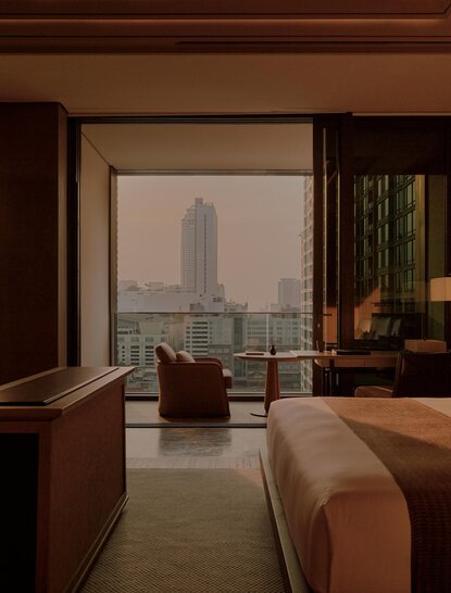 Terrace Suite at Aman Nai Lert Bangkok with city views through floor-to-ceiling windows.
