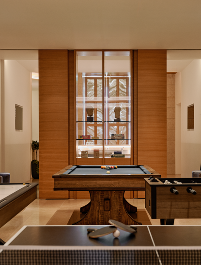 Sala de juegos en Amanzoe con mesa de ping pong y muebles de madera en resort griego.