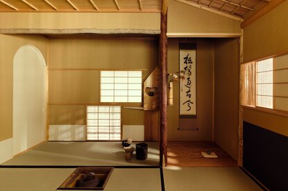Wooden tea house interior at Aman Kyoto with tatami mats, sliding screens and natural light.