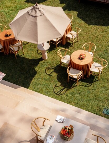Wedding ceremony setup at Amanbagh with parasol and seating on manicured lawn.
