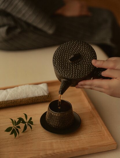 Spa treatment detail at Aman Tokyo showing traditional massage tool on wooden surface.