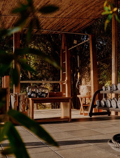 Spa and wellness gym at Aman-i-Khas with wooden architecture, natural light, and greenery.