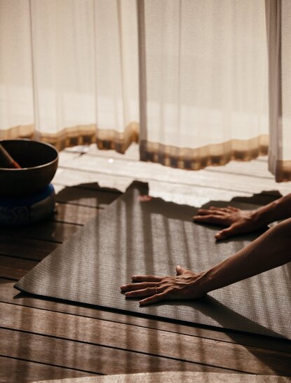 Spa treatment room at Amanyara with massage table and flowing white curtains.