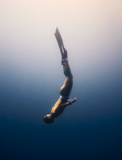 Freediver Alexey Molchanov descending into clear blue waters at Amanyara, Turks and Caicos.