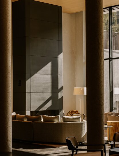 Winter garden at Aman Rosa Alpina with dark architectural feature and warm lighting.