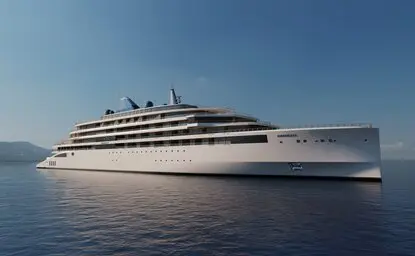 Aman at Sea, a modern white ship, cruises through calm blue waters with distant mountains on the horizon.