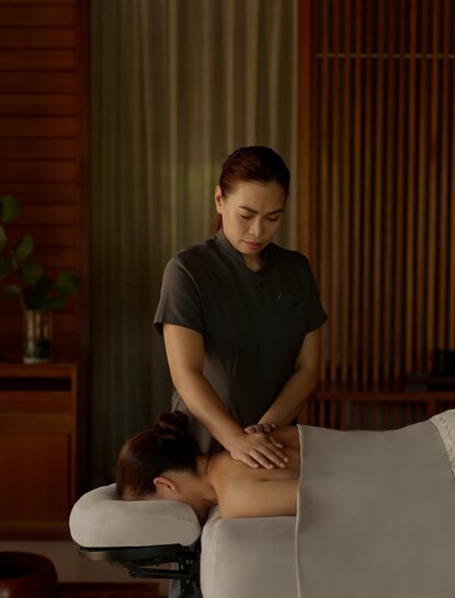 Therapist performing a massage treatment at Amanyara's spa wellness facility.