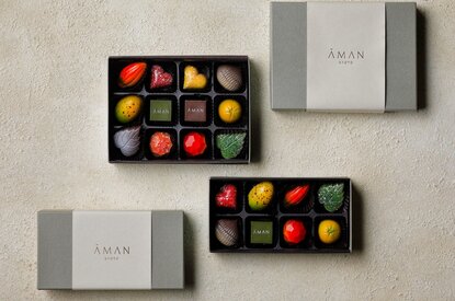 Aman Kyoto resort: Colourful chocolates arranged in white boxes on a neutral surface, displayed flat lay for White Day gifting.