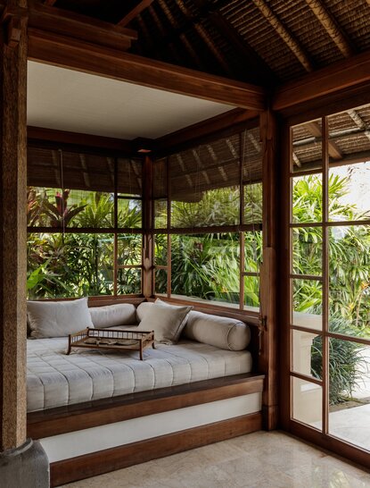 Duplex daybed pavilion at Amandari with wooden beams and garden views through open doors.