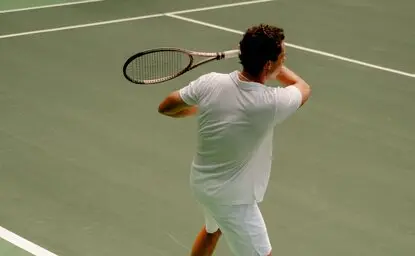 Model playing tennis on the court at Amanera resort, Thailand.