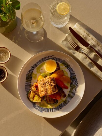 Plated dish with roasted vegetables and egg at Amanyara resort's beach club restaurant.