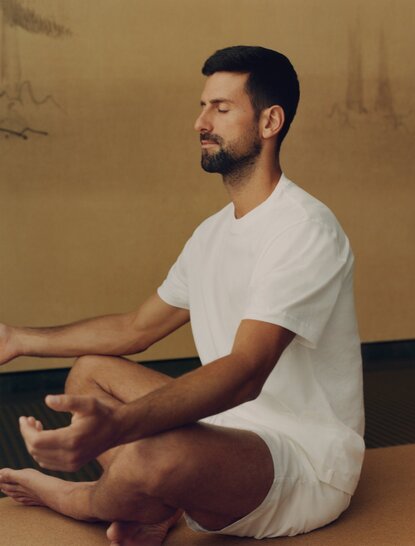 Novak Djokovic meditating in a serene studio space at Amanoi.