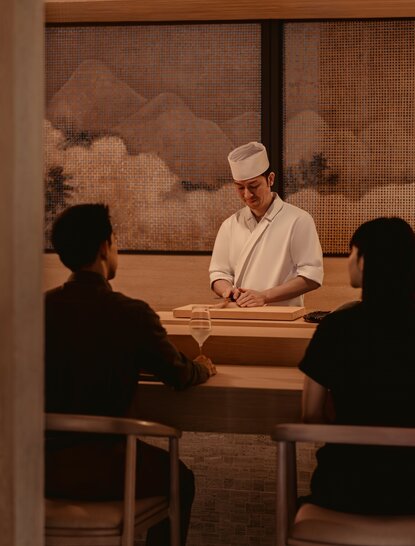 Sesui guest dining with staff member at Aman Nai Lert Bangkok, Thailand.