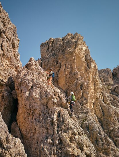 Towering rock formations of the Dolomites at Aman Rosa Alpina, Italy, under clear summer skies.