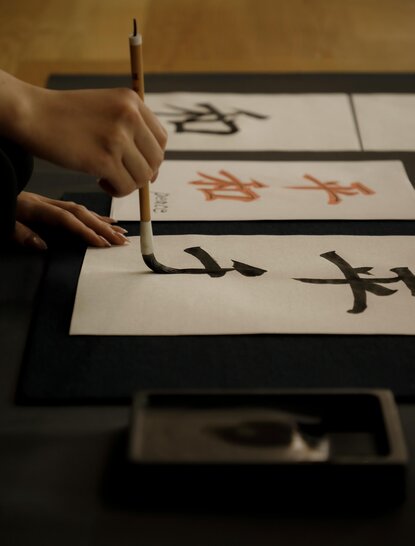 Hand practising Japanese calligraphy at Aman Tokyo.