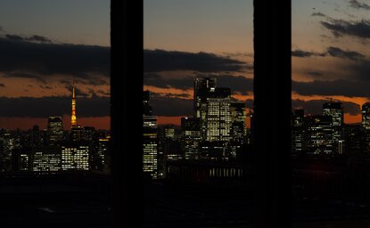 Tokyo's skyline at dusk, viewed through silhouetted columns at Aman Tokyo.