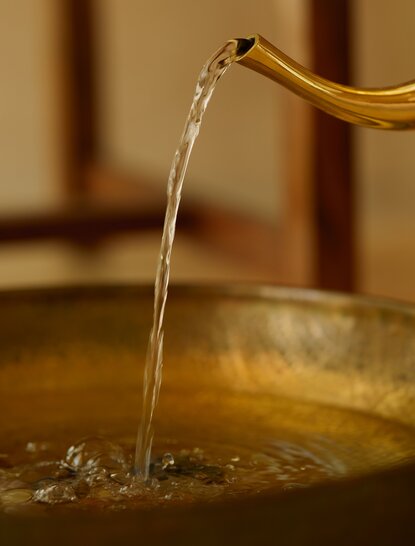 Water being poured into a spa treatment bowl at Amanbagh, India.