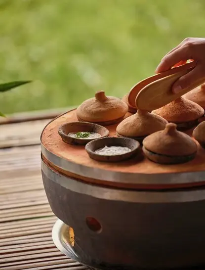 Afternoon tea bánh căn served on wooden board at Amanoi, Vietnam.
