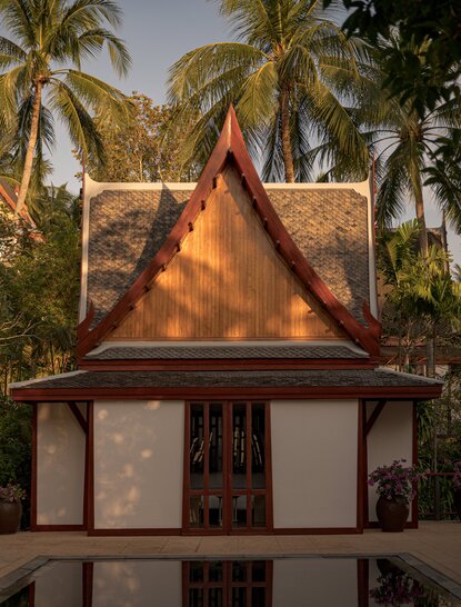 Seven-bedroom garden villa with outdoor pool at Amanpuri, Thailand, featuring traditional Thai architecture and palm trees.