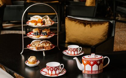 Afternoon tea service at Aman Venice with tiered stand, pastries, teapot and cups.