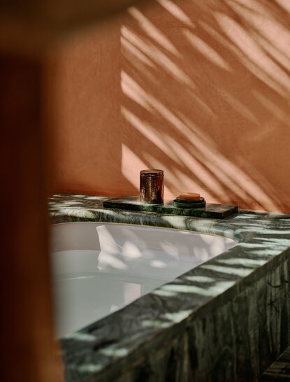 Pool pavilion with striped sunlight at Amanjena, Morocco.
