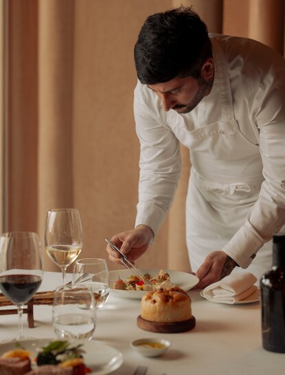 Chef preparing a dish at Amanjena resort in Morocco.