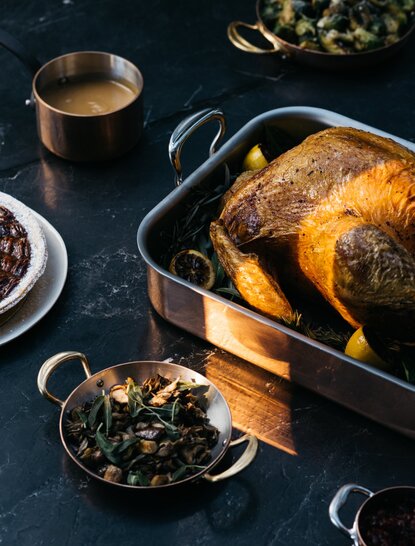 Roasted turkey with autumn herbs and sides prepared for Thanksgiving dinner at Aman New York.