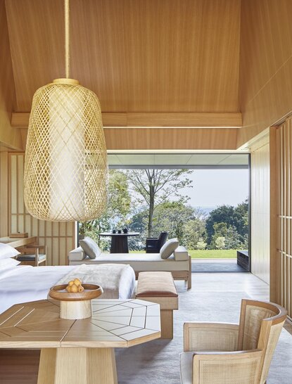 Sora Suite at Amanemu with wooden interiors, pendant lighting, and garden views through expansive windows.