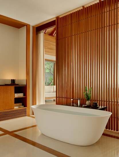 Alcove Pavilion bathroom at Amanyara with freestanding tub and timber-clad walls.