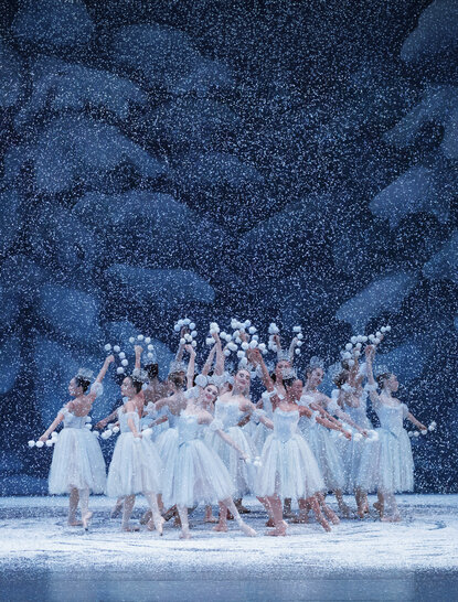 New York City Ballet dancers in white tutus gathered on stage during a behind-the-scenes moment at Aman New York.