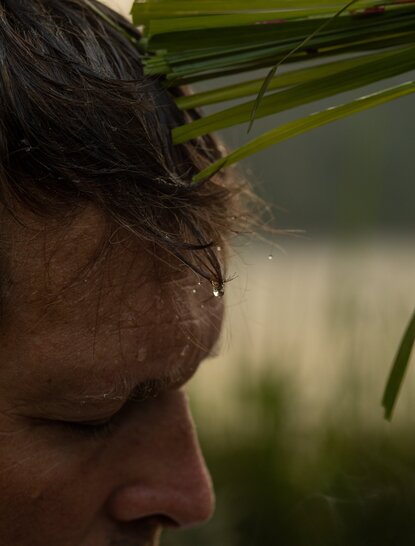 Close-up of a guest's face in profile during a wellness ritual at Amanjiwo, Java.