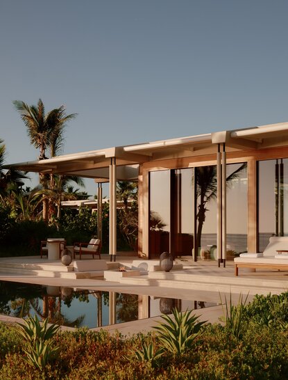 Beachfront casita at Amanvari with terracotta exterior, wooden pergola, and desert garden in Mexico.