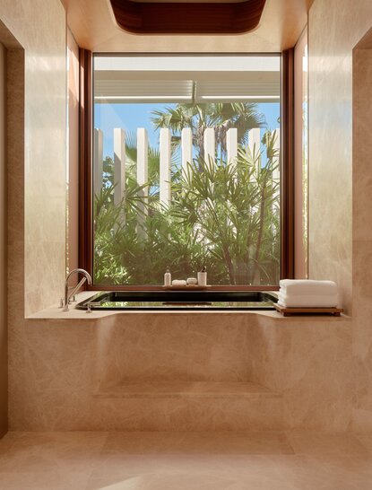 Beachfront estuary casita bathroom with window overlooking vegetation at Amanvari, Mexico.