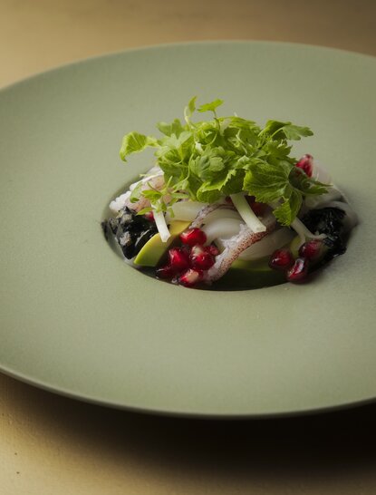 Assiette de salade verte garnie de betteraves et olives noires au restaurant d'Aman Kyoto.