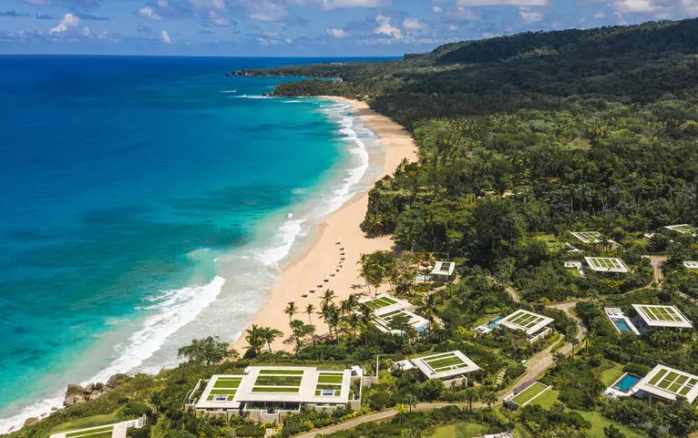 Aerial view of Amanera resort's coastline with turquoise waters, sandy beach and lush vegetation.