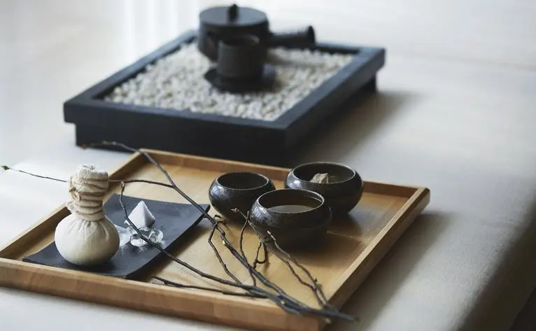 Kuromoji tea journey display at Aman Tokyo featuring traditional tea preparation tools and accessories arranged on wooden trays.