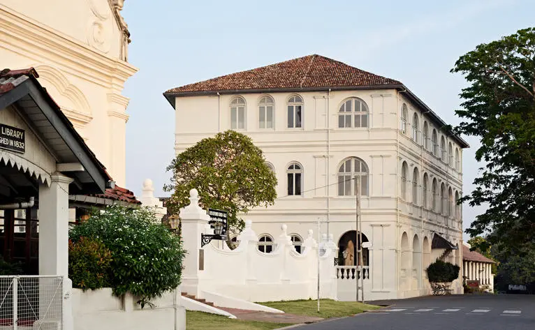 Amangalla's exterior featuring a multi-storey colonial building with cream-coloured facades and traditional architectural details.