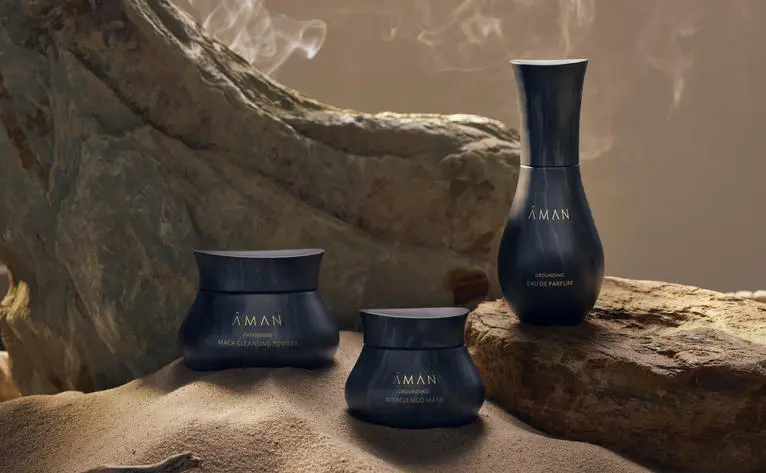 Dark ceramic vessels displayed with natural wood and stone at Amanjiwo.