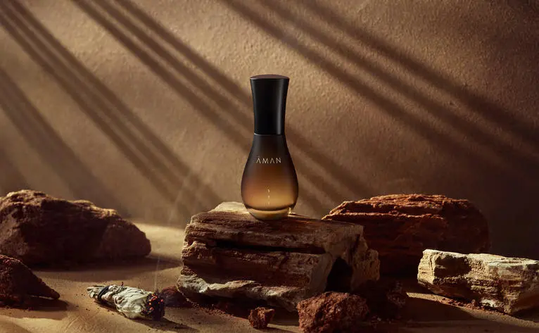 Sei fine fragrance bottle displayed amongst natural materials and warm sunlight at Amangiri resort.