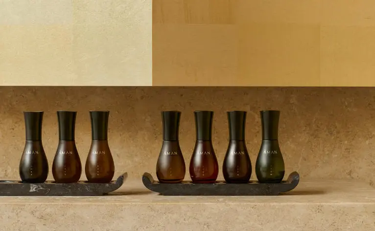 Aman Essentials spa product bottles arranged on a shelf at Amanzoe, Greece.
