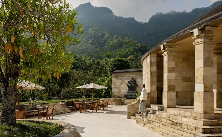 Terrace staff area at Amanjiwo resort overlooking terraced gardens and mountain peaks in Central Java.